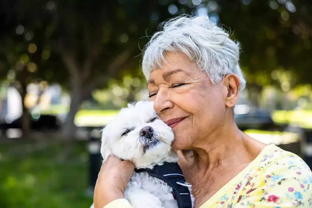 ABOUT-Furry Friends Senior woman cuddling with her dog